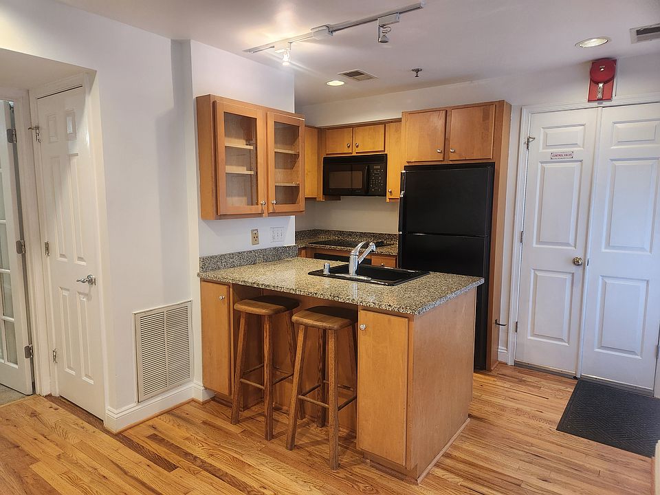 Kitchen with built-in oven, microwave, cooktop, dishwasher and refrigerator.