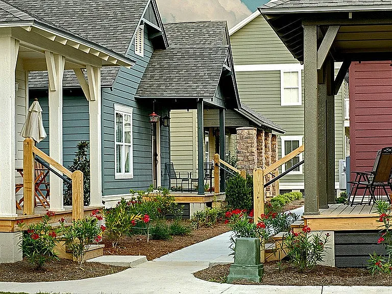 Experience cozy living in a vibrant neighborhood with inviting porches and lush gardens.