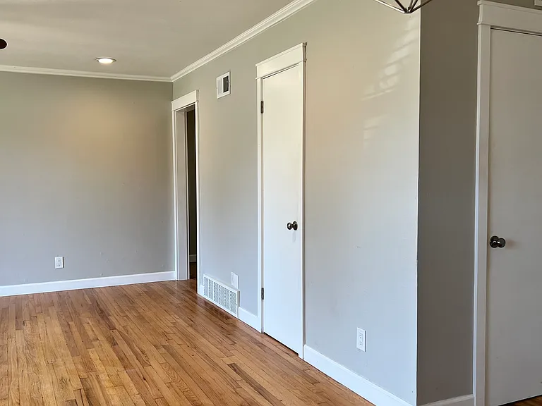 Living room looking from the dining room.
Coat closet and storage closet doors shown.