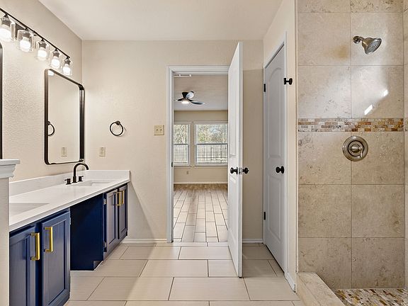 Luxury primary bathroom: completely updated with modern vanities, quartz counters, and a massive walk-in master shower