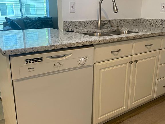 Kitchen has a dishwasher and is open to living space