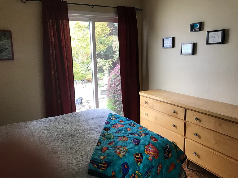 Bright Bedroom with views and access to the garden.