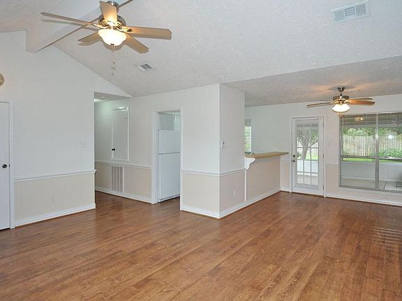 Open living room with wood laminate flooring and upgraded fans