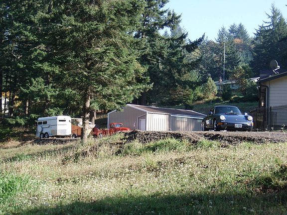 View from road of 1 acre pasture/shop.