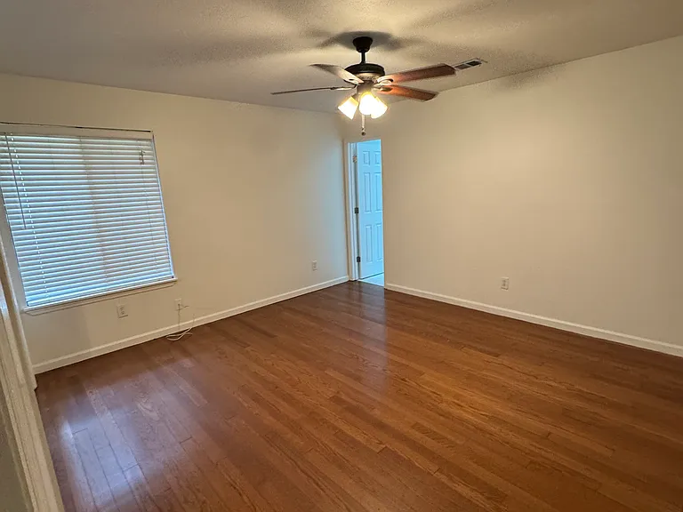 Primary bedroom with view of bathroom door