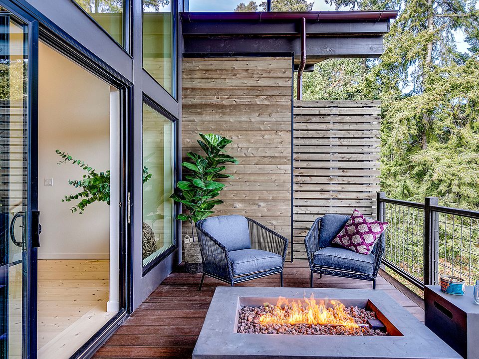 A covered deck on the upper level extends the main living space.