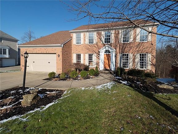 This stately brick home features a level driveway and 2 car attached garage.