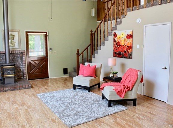 Ample great room with laminate flooring and vaulted ceilings.