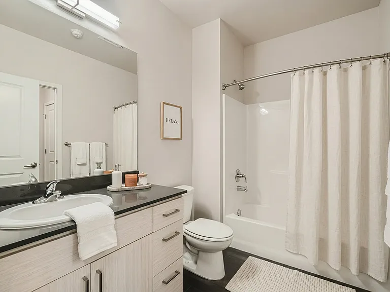 A clean, modern bathroom with a full shower and tub.