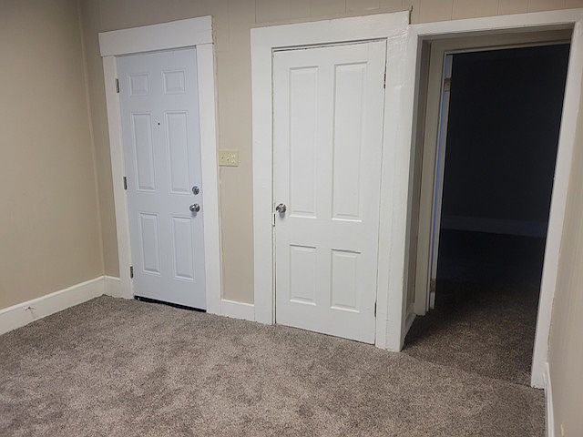 Living room - with entry door is on the left and the bedroom is on the right.