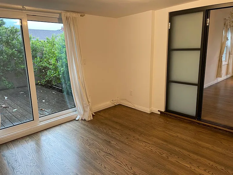 Bonus room/den with a locking sliding glass door.