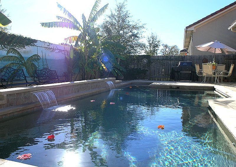 Salt water pool with waterfall, fountain, and patio 