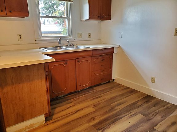 Kitchen sits as the hub for everything in the house. It has new flooring and fresh paint - cabinets are pretty good for a rental. counter shows the age, but it works.