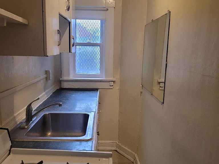 Kitchen with cabinets above and two large pantry closets on the side , refrigerator, gas oven,