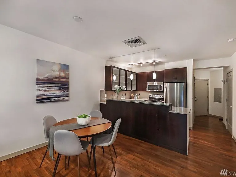 Dining space in front of kitchen with breakfast bar