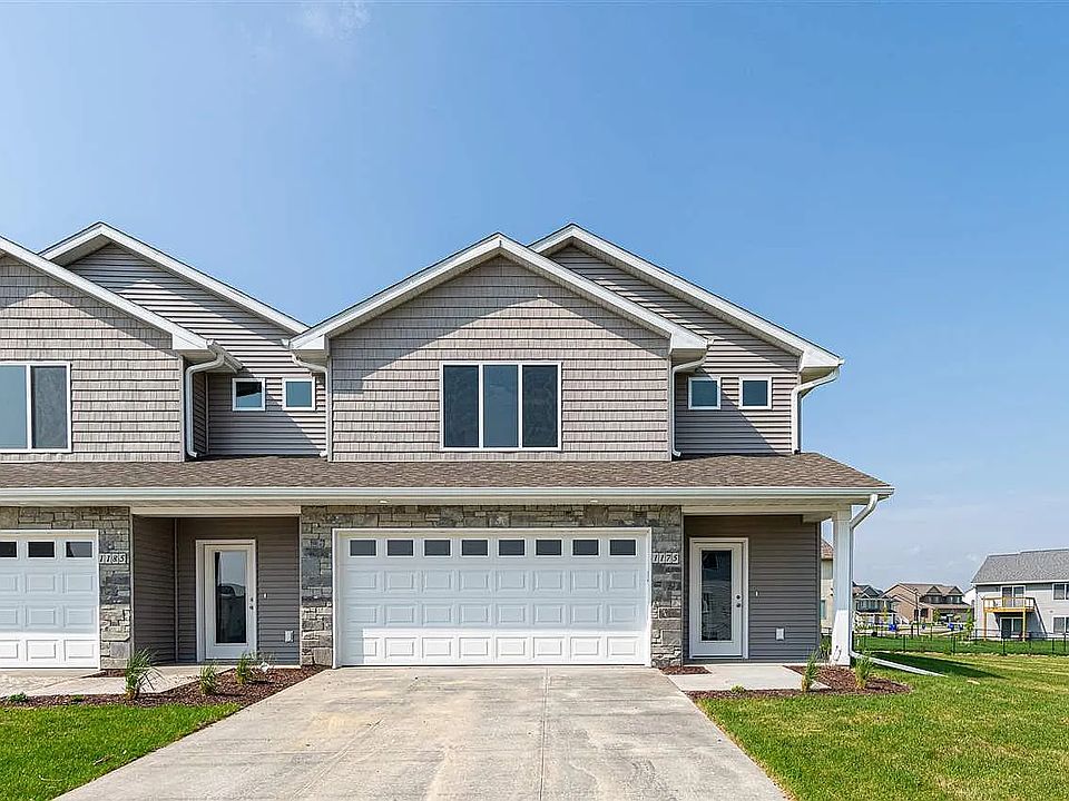 Front of the townhouse, large driveway with a 2-car garage