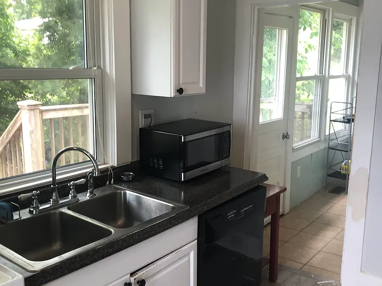 Kitchen looking toward hallway with stacked laundry