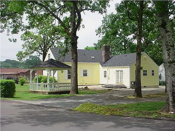 rear of home ample parking with circular driveway