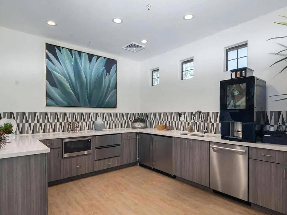 Community Kitchen with Coffee Bar and Stainless Steel Appliances