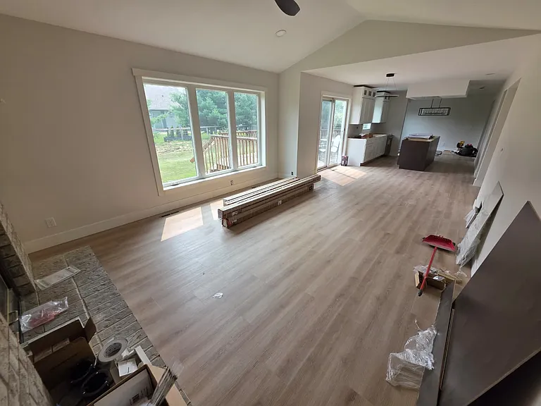 Open concept wood burning fireplace room with informal dining space and kitchen. All new Anderson windows throughout the home.