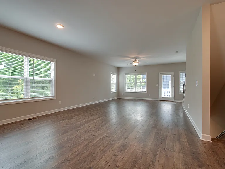 The living space is drenched in natural light and offers great privacy with views to the green space adjacent to the property.