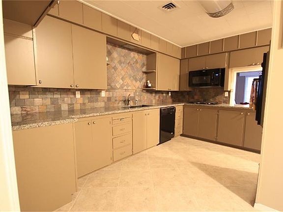 Kitchen with granite counter tops and new appliances