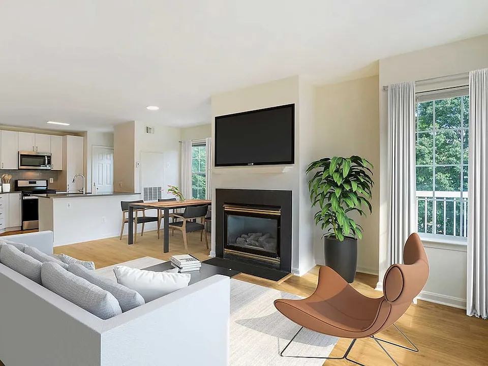 Renovated Package IV kitchen, living, and dining areas with hard surface plank flooring