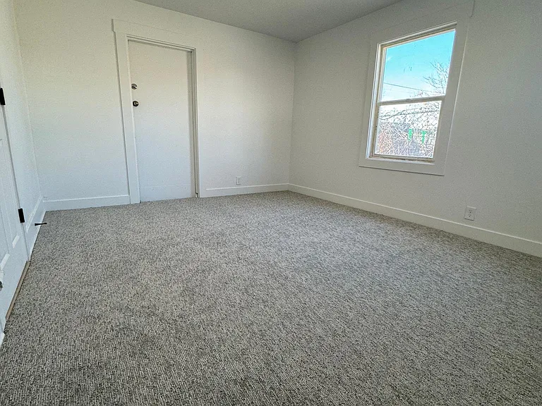 Bright and comfortable primary bedroom with updated flooring and a clean, modern feel.