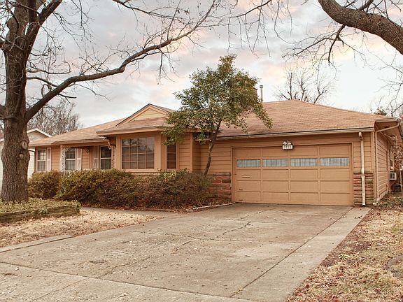 A wide driveway leads to the two car garage.