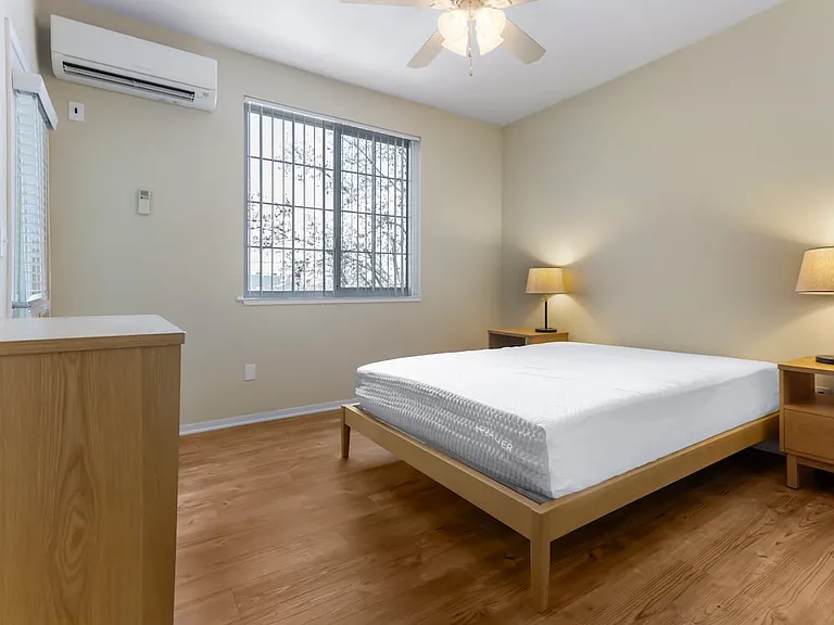Furnished+ apartment homes feature queen bed with mattress, dresser, nightstands, and lamps (Representative Image exact items and style of furnishings may vary)