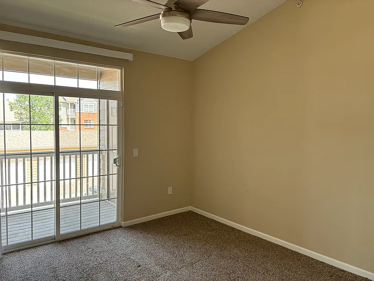 Master bedroom with vaulted ceiling and decorative cutout space. Attached to its own patio, outdoor storage closet, walk-in closet, and bathroom