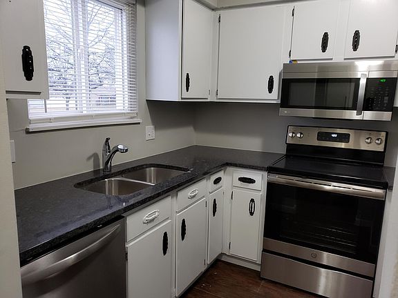 Kitchen with new granite counter-top, new stainless steel appliances, and freshly painted cabinets