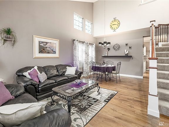 Formal living room and dining room with vaulted ceiling
