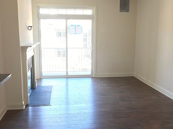 Living area with balcony and electric fireplace