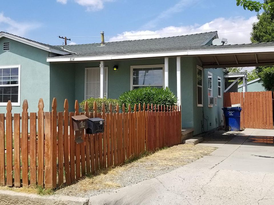 Front of house faces south. Gate in driveway covers up one car garage adding privacy.