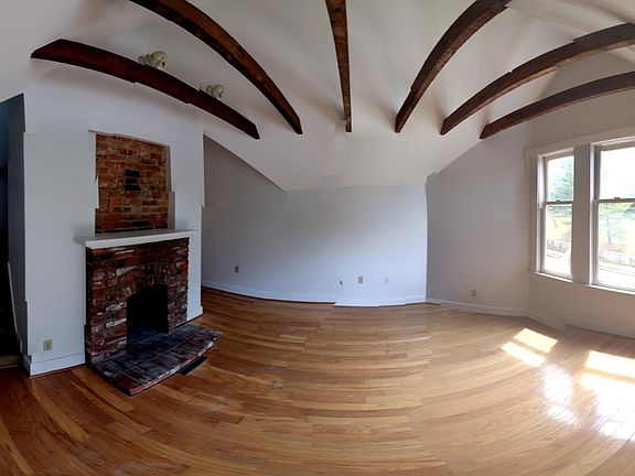 Living room with hardwood floor and exposed wood beans