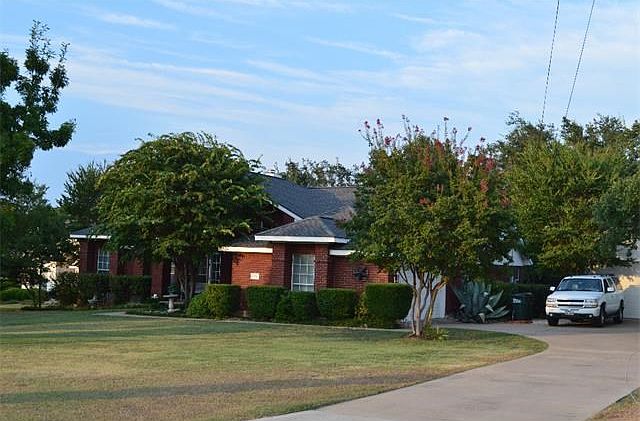 Beautifully landscaped home with large front lawn, 2 car attached, 2 car detached garage and RV parking!