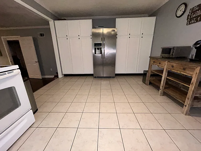 Another view of the kitchen highlighting abundant cabinet space.