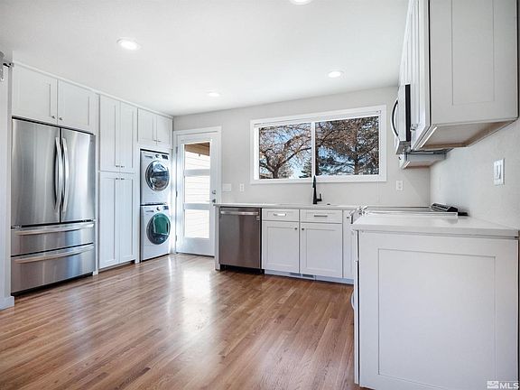 Kitchen with clothes washer and dryer.