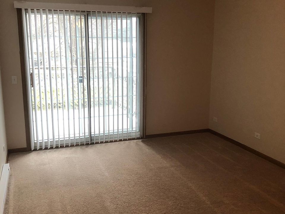 Large living room with ceiling fan and sliding glass doors onto wooden deck