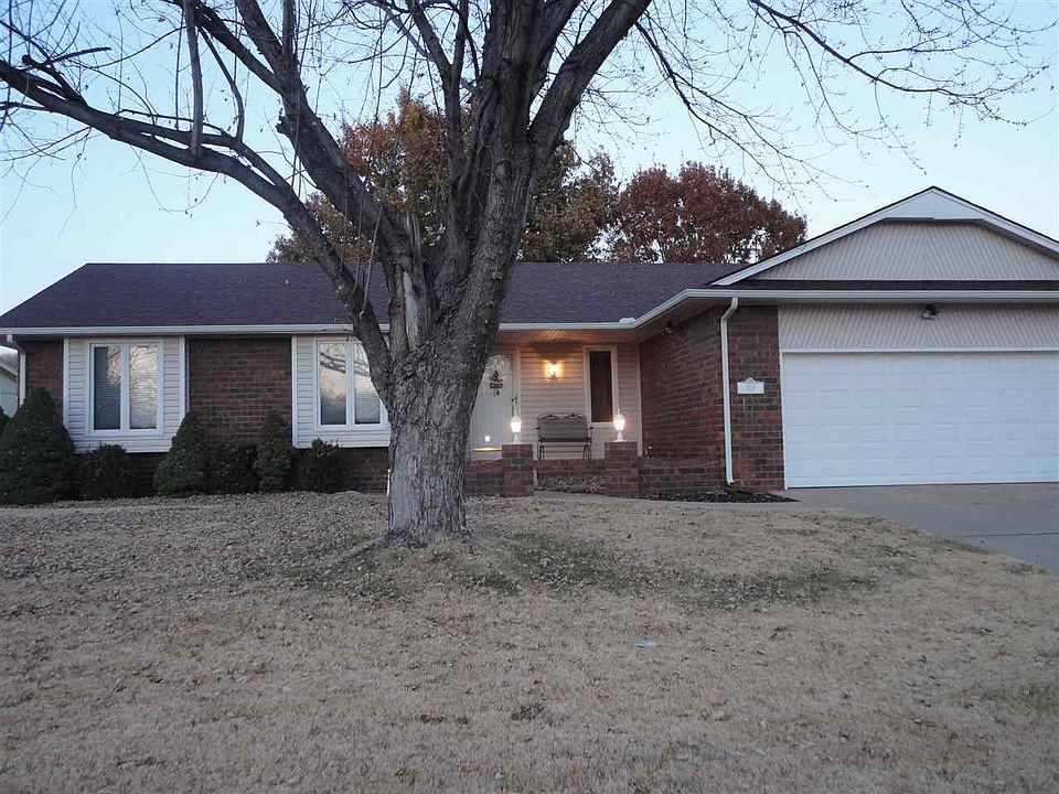 Front of house is brick with working carriage lights on each side of porch area.  2 car attached garage. RV parking behind gate next to garage with hook ups for RV.