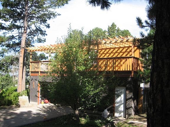 Driveway View of Deck and Arbor