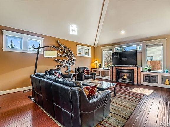 The great room with soaring ceiling, which opens to upstairs loft. 