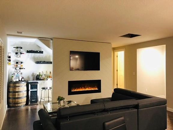 Sliding TV wall with hidden bar