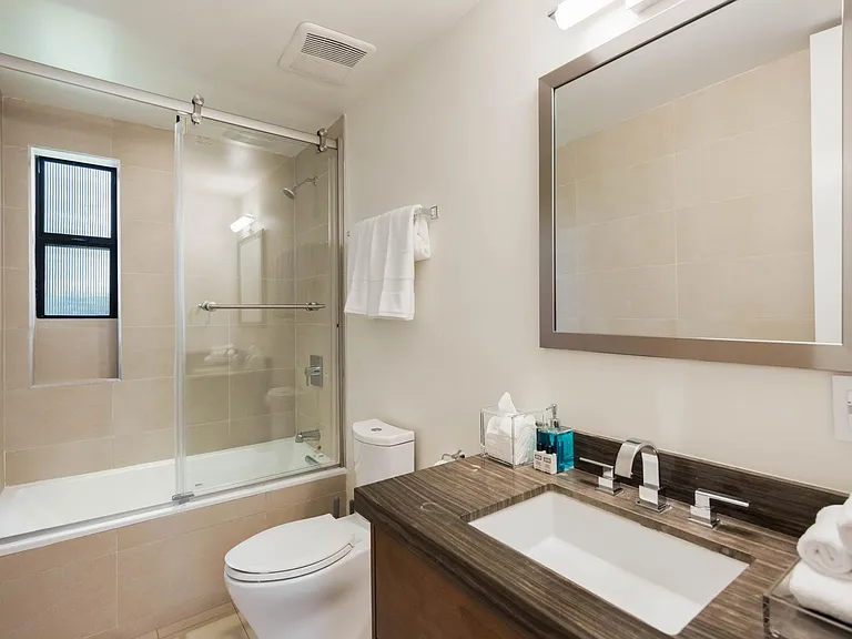 The bathroom is fully stocked with all essentials, including luxurious premium amenities and plush towels.