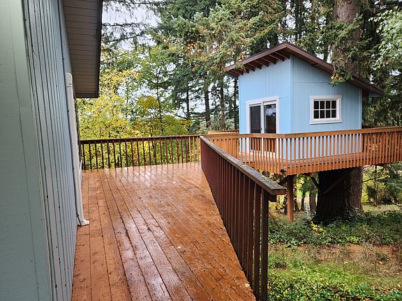 Tree house connected to large deck.