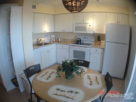 Dining are looks over screened porch to Gulf