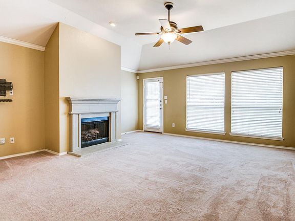 Spacious living room featuring ceiling fan, lots of natural light and access to backyard