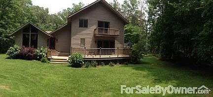 Back view
						:
						Mature landscaping and multi-level decks with absolute privacy.