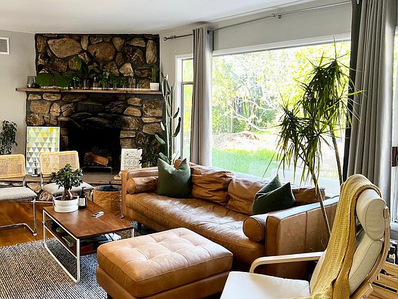 Living room area with view into backyard (unit is unfurnished, this just shows example furnishing)